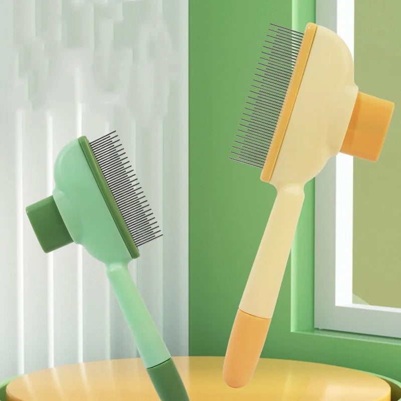 Two pet grooming slicker brushes in sage green and cream yellow, featuring fine metal bristles and ergonomic handles.