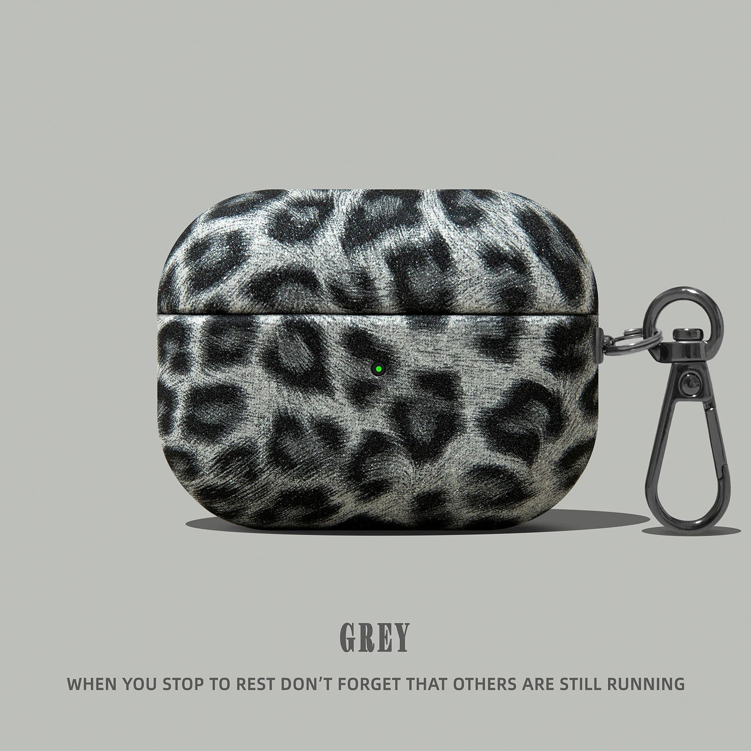 Grey leopard print AirPods Pro case with textured finish and black metal keyring.