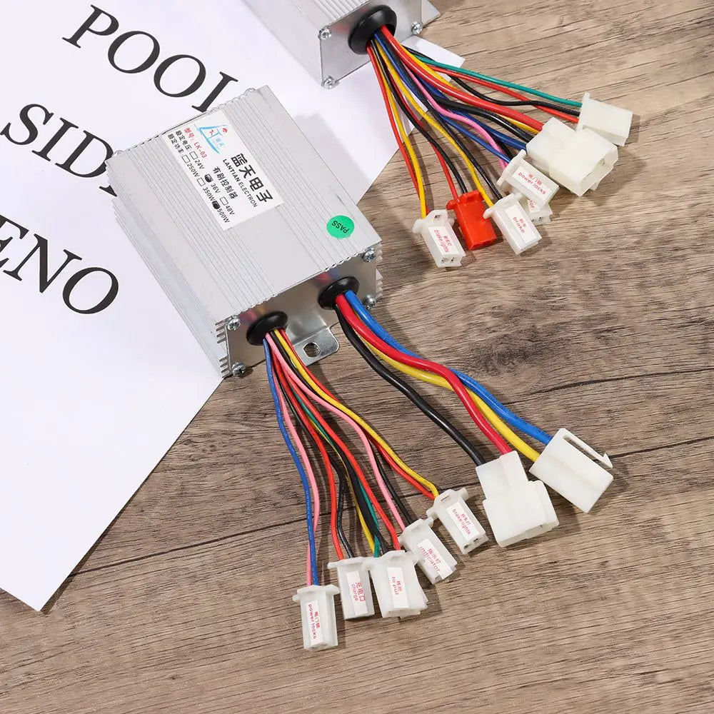 Silver rectangular electric bike brushed motor controller with multiple multicolored wires and white connectors.
