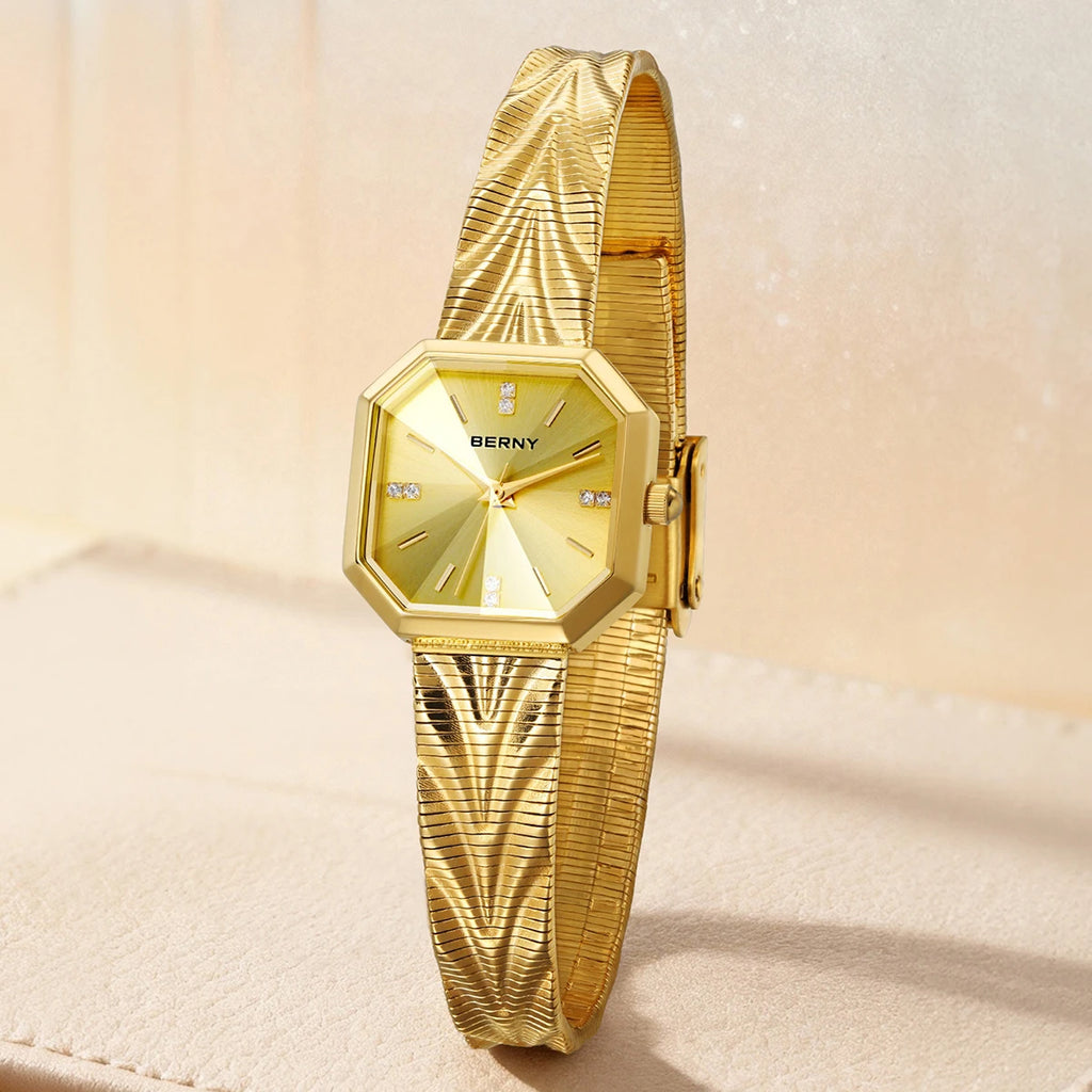BERNY gold women's watch with an octagonal case, sunburst dial, and textured mesh stainless steel band.
