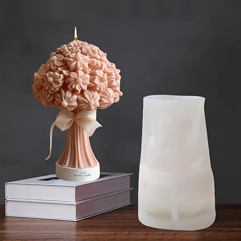 Light pink 3D flower bouquet candle with a bow, next to a translucent silicone mold.