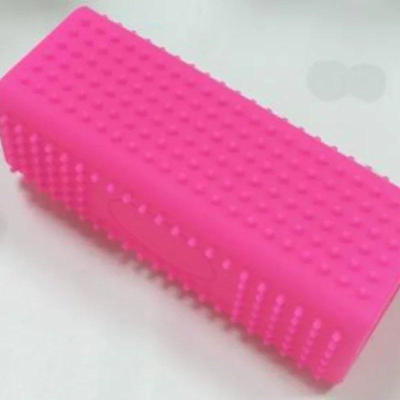 Bright pink rectangular silicone lint roller brush with a textured, studded surface for removing pet hair and fluff.