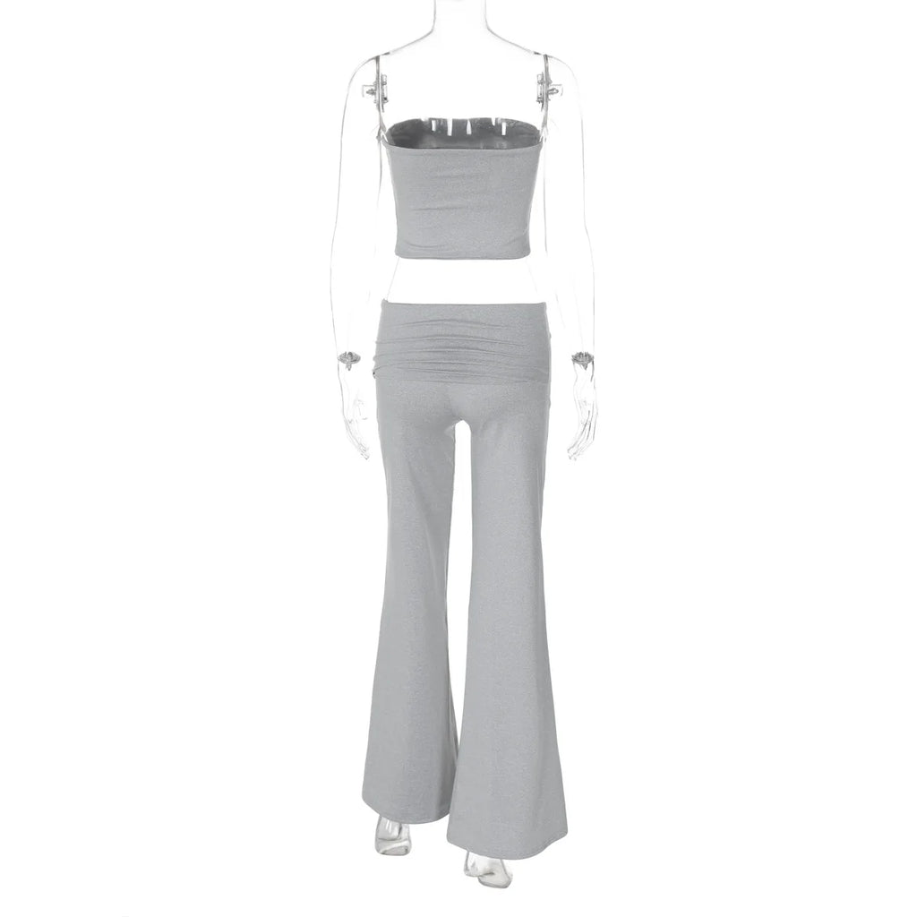 Back view of a grey, two-piece matching set featuring a strapless crop top and high-waisted flared trousers.