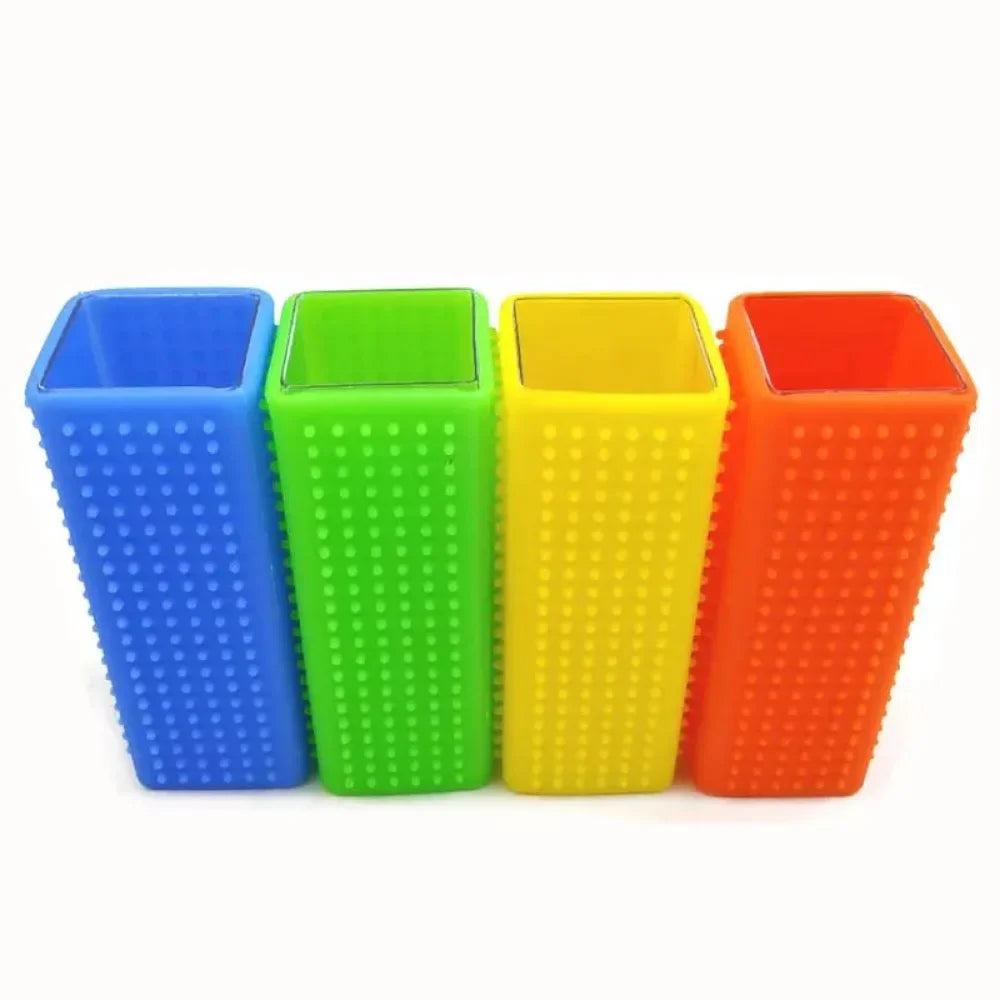 Four tall, square silicone pen holders in blue, green, yellow, and orange, featuring a textured, studded exterior.