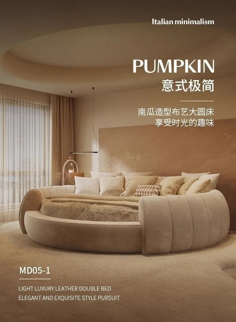 A circular, beige upholstered bed with a channel-tufted frame, set in a modern, minimalist neutral bedroom.