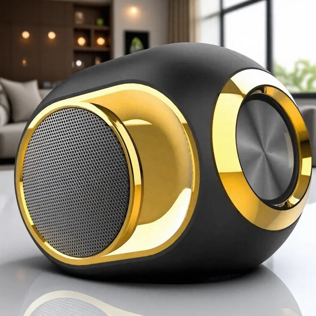 Modern, compact matte black portable Bluetooth speaker with gold accents and a metallic circular speaker grille.