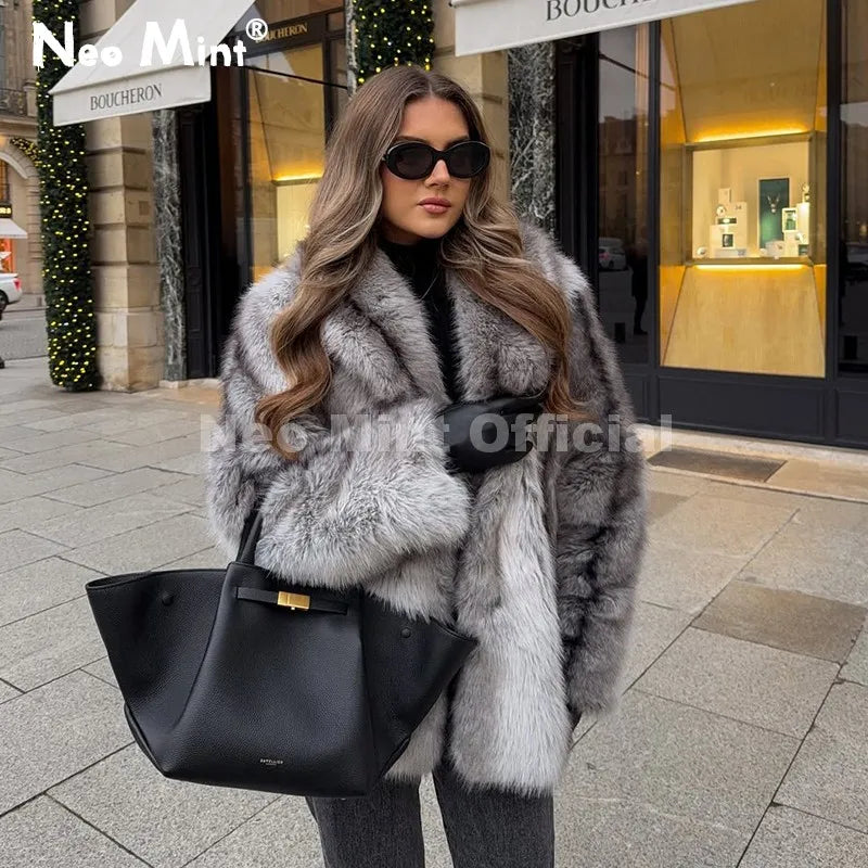 Brown striped faux fur coat with a scarf collar, worn with a black handbag.