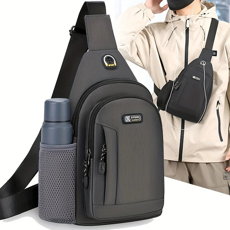 Dark grey men’s oxford chest bag with a crossbody strap, zipped compartments and a side mesh water bottle holder.