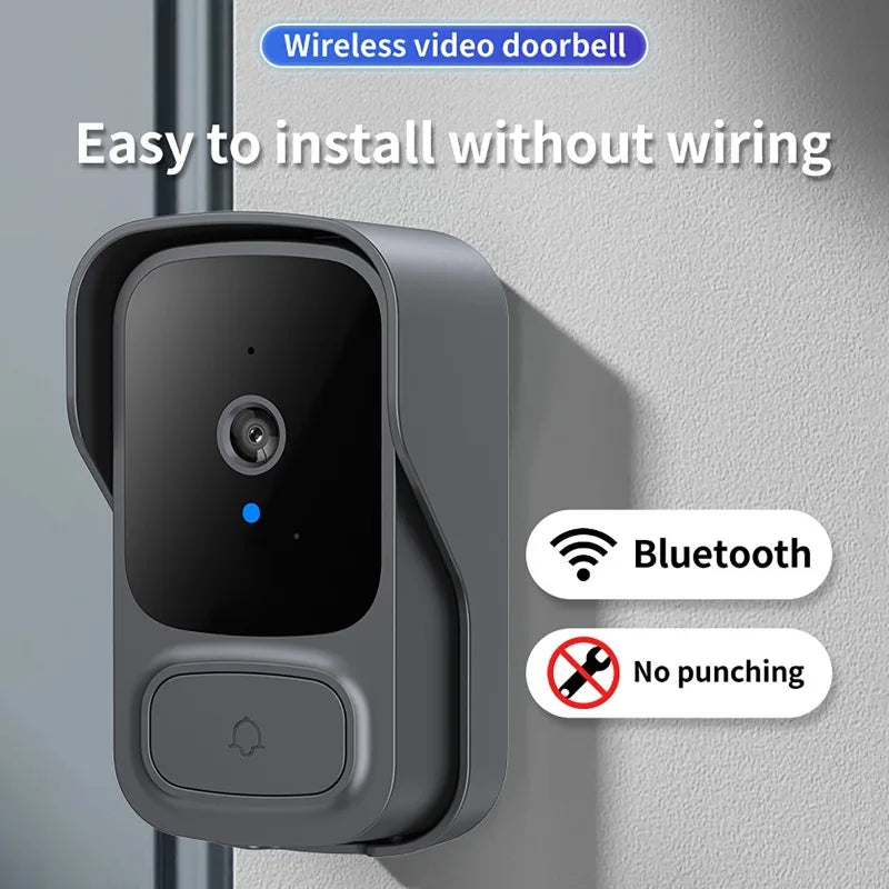 A sleek, grey wireless video doorbell with a camera, blue indicator light, and doorbell button mounted on a wall.