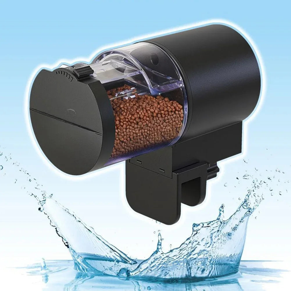 Black automatic aquarium fish feeder with a clear, cylindrical food container, featuring a modern, compact design.