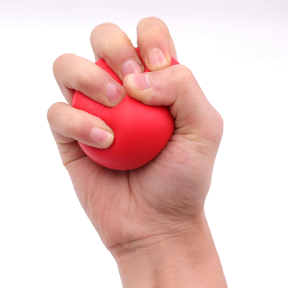 A hand tightly squeezing a bright red stress ball against a plain white background.