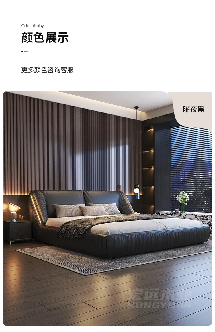 Modern luxury king-size bed frame in black leather with a curved, padded headboard in a stylish, contemporary bedroom.