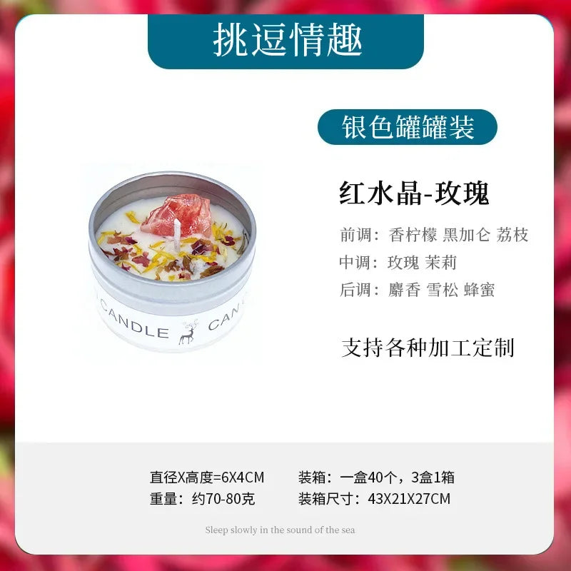 A small scented candle in a silver tin, topped with a red crystal and dried flower petals.