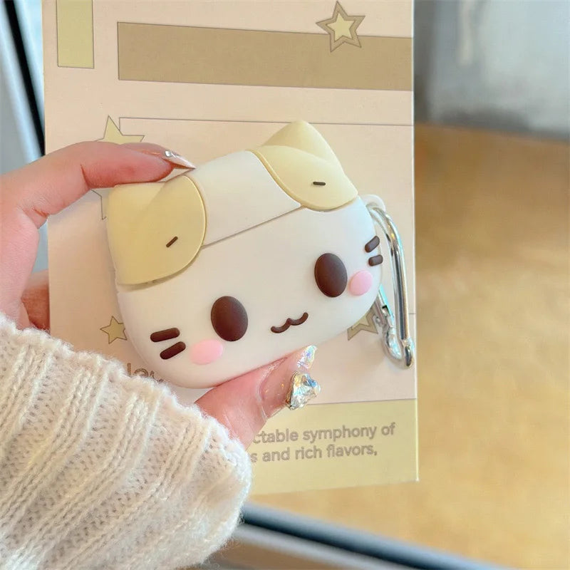Cute cream and white silicone cat-themed AirPods case with a silver keychain clip.