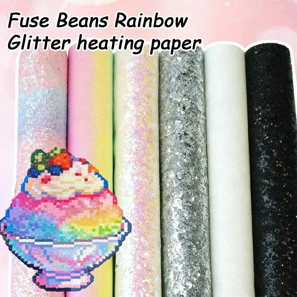 Six rolls of glitter fuse bead ironing paper in assorted colours, featuring a rainbow dessert pixel art design.