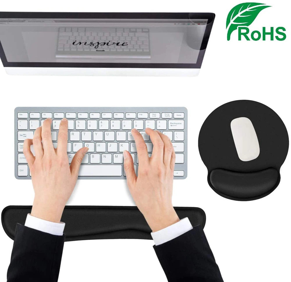 Silver wireless keyboard and white mouse on a black foam wrist rest and ergonomic mouse pad with support.