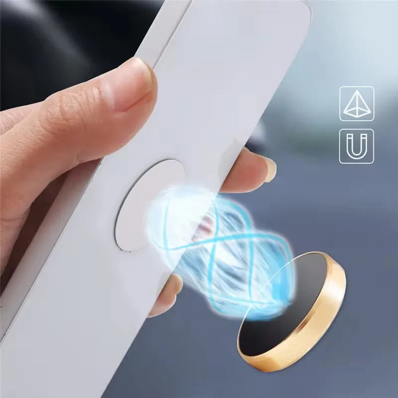 Hand holding a white smartphone with a round, gold magnetic phone mount attached via a blue glowing force field effect.