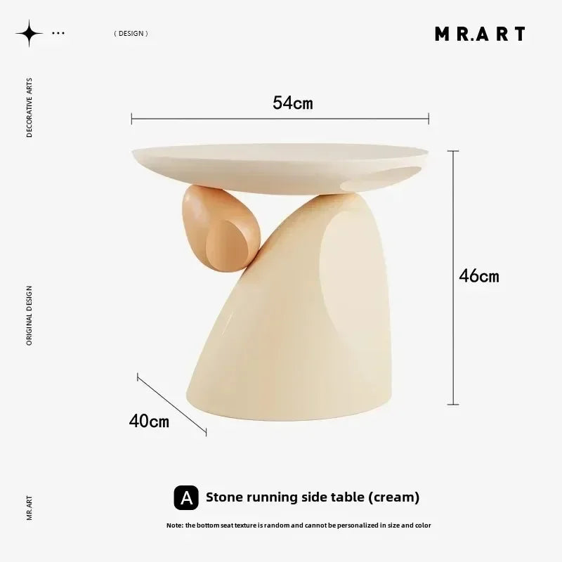 Minimalist cream-coloured side table with a sculptural, abstract base and round top. Measures 54cm wide by 46cm high.