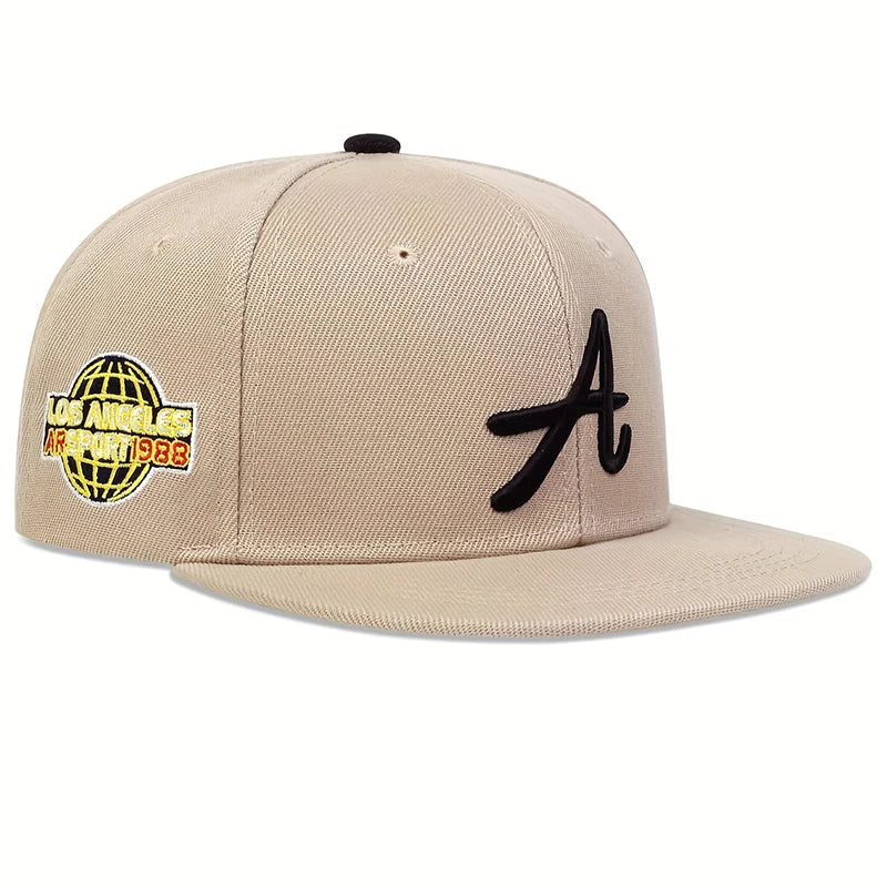 Beige unisex baseball cap with a black embroidered 'A', featuring a globe logo patch on the side.