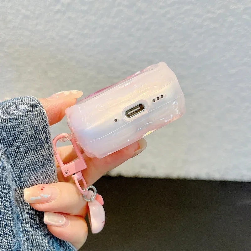 Pink, translucent protective case for AirPods Pro, featuring a keyring attachment.