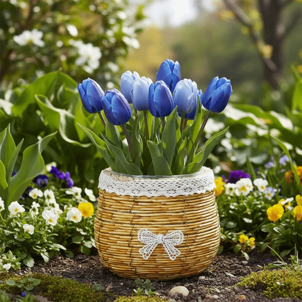 Blue tulips in a rustic, woven tan basket with a white lace rim and a small lace bow, set in a sunny garden.