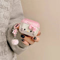Pink Hello Kitty AirPods Pro case in clear, hard-shell plastic with a matching charm and pom-pom keychain.