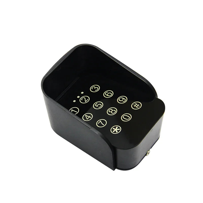 Black plastic wall-mounted keypad with white numbers, symbols, and a protective hood for security access.