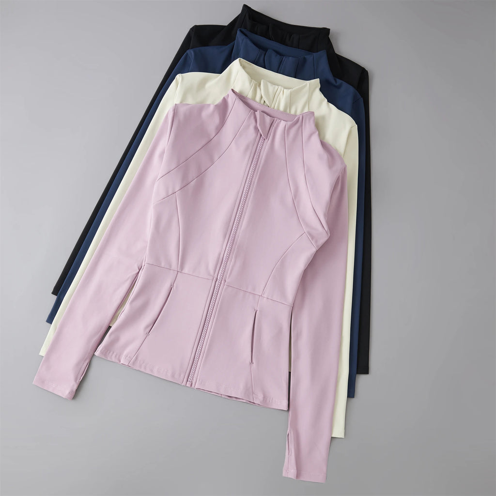 Stack of women’s zip-up sports jackets with high collars in pink, cream, navy, and black.