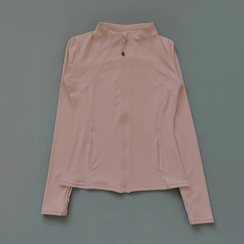 Pale pink athletic zip-up jacket with a high collar, tailored seams, and long sleeves with thumbholes.