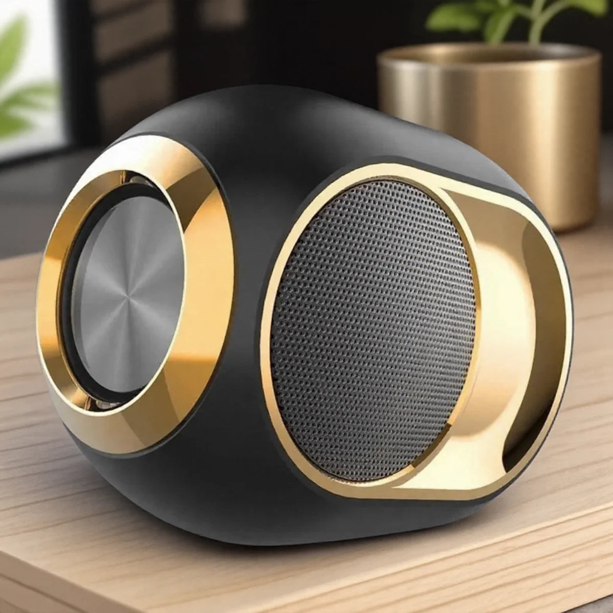 Compact, rounded black Bluetooth speaker with gold accents, metallic speaker grille, and a modern, stylish finish.