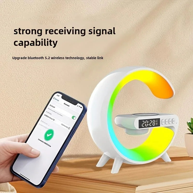 White G-shaped Bluetooth speaker with multi-colour RGB light, wireless charging pad, and digital alarm clock display.