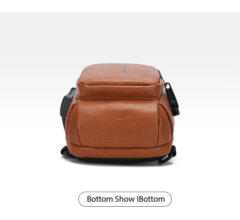 Tan faux leather anti-theft crossbody sling bag, showing the base with a side USB charging port.