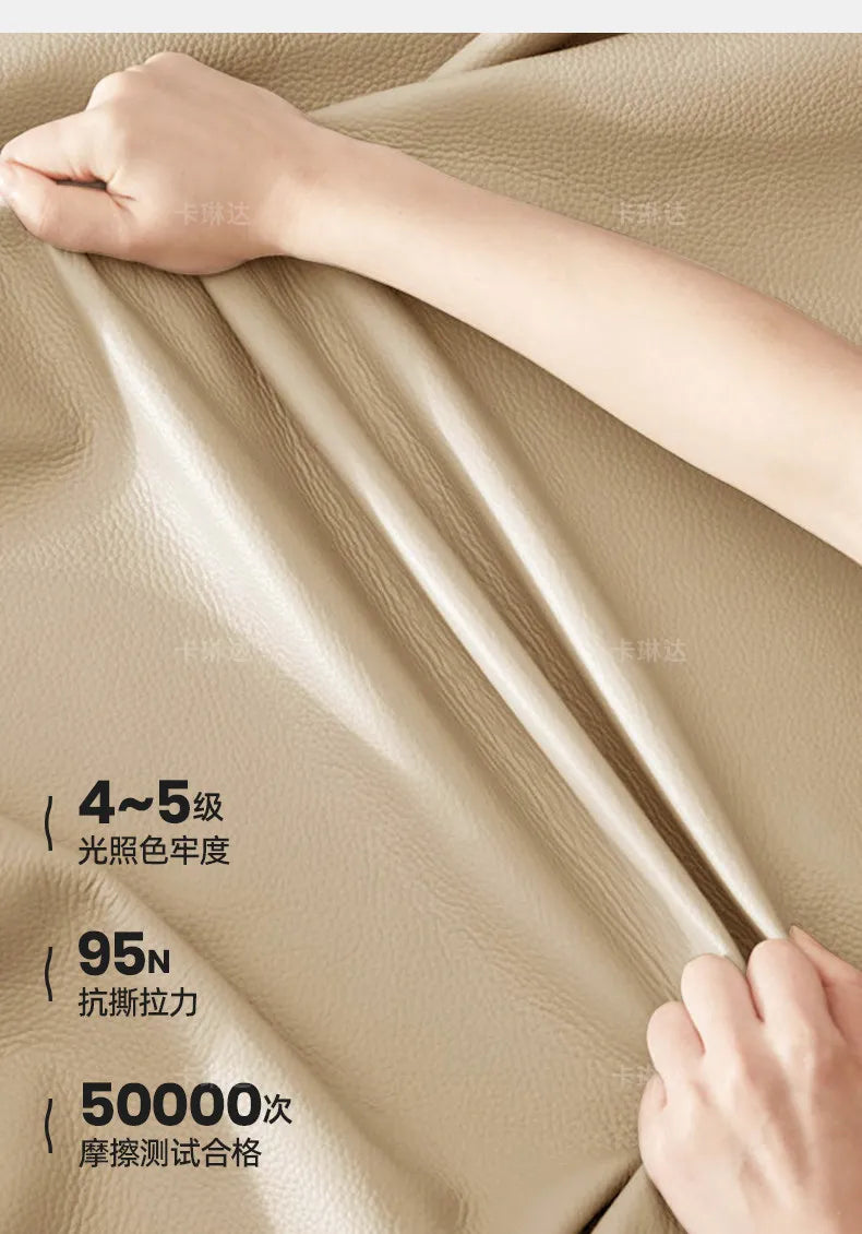Close-up of high-quality, cream-coloured textured upholstery fabric being pulled to show its durability and finish.