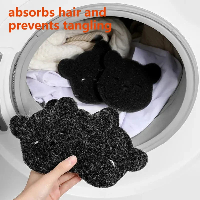 Hand holding black bear-shaped laundry hair catchers, with more inside a washing machine.