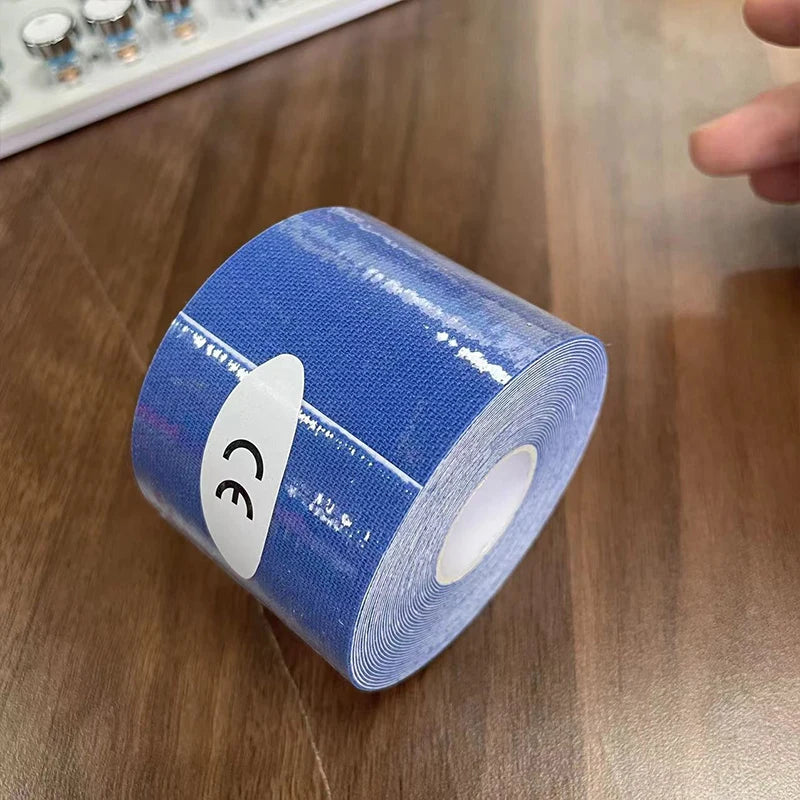 A roll of blue kinesiology sports tape featuring a CE certification sticker on a wooden surface.