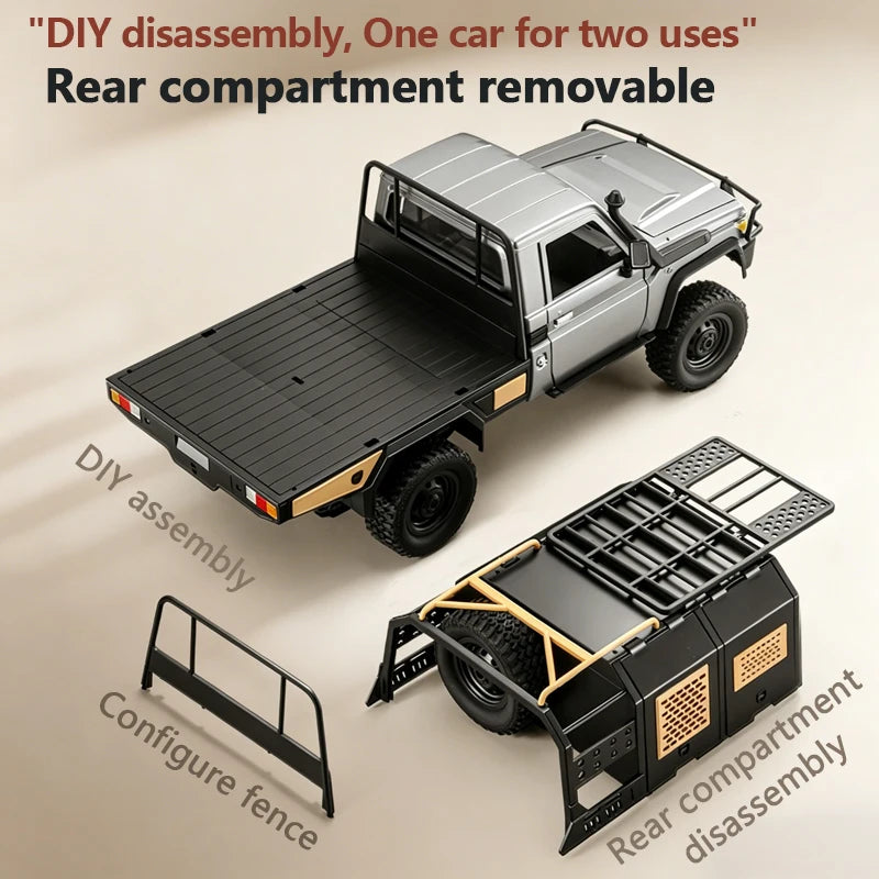Silver 1/12 4WD RC pickup truck with black flatbed, off-road tires, fence, and removable rear camper shell.