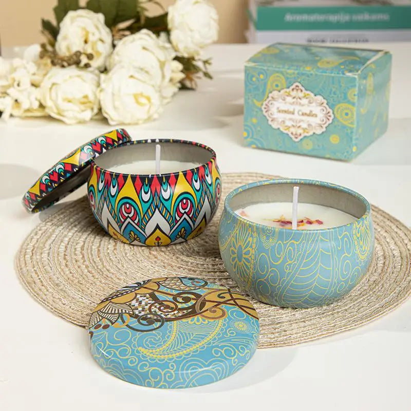 Two colourful scented candles in decorative metal tins with bohemian patterns, featuring matching lids and gift box.