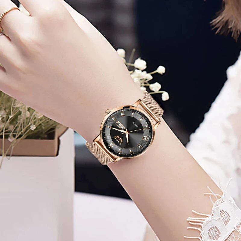 Elegant women’s rose gold mesh bracelet watch featuring a round black dial with Roman numeral markers.