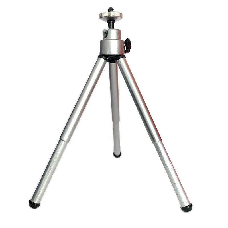 Silver mini camera tripod with an adjustable ball head and telescopic legs, isolated on white.