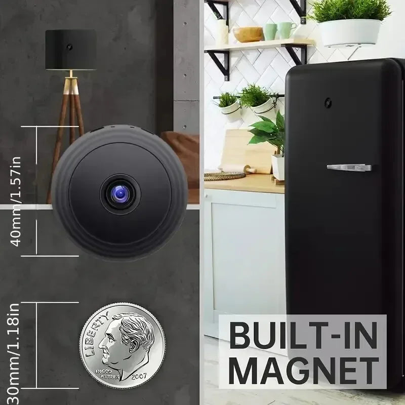 Small round black plastic wireless security camera with a built-in magnet, shown next to a US dime for scale.