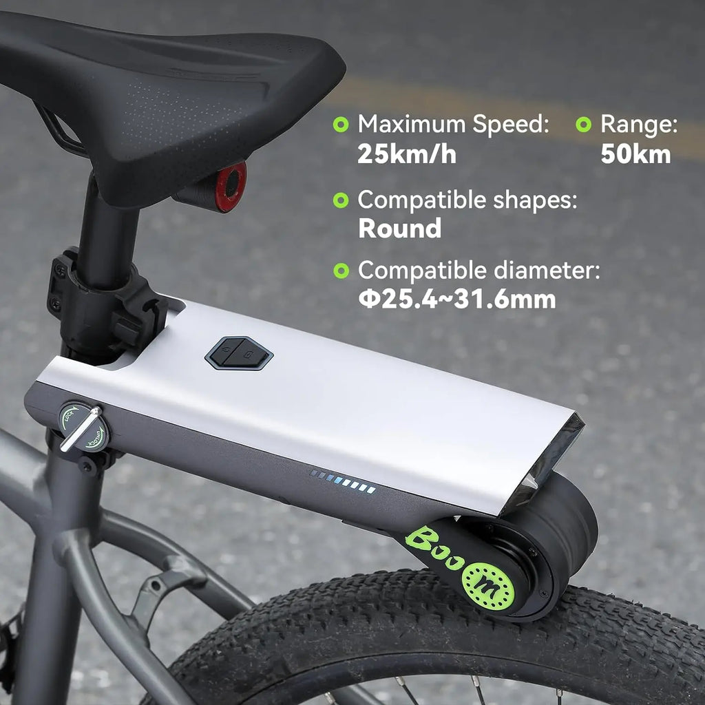 Silver and dark gray electric bike booster mounted below a bicycle saddle, featuring a drive roller touching the rear tire.