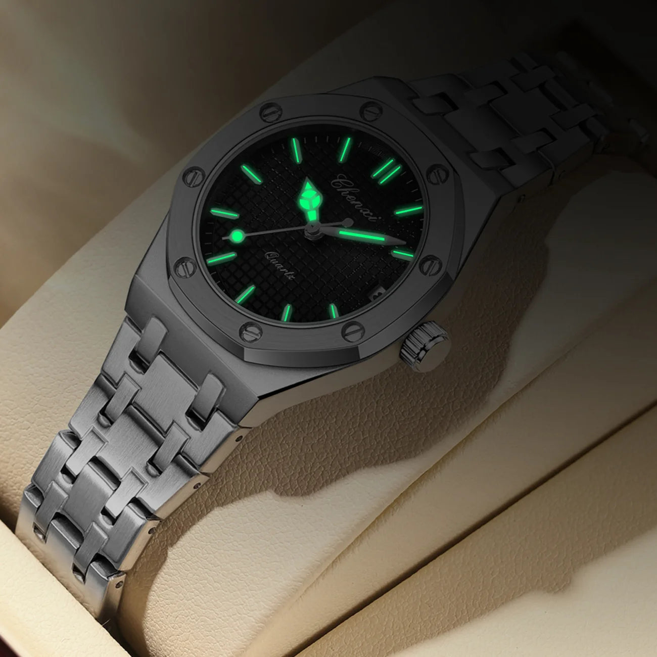 Luxury women’s silver stainless steel analogue watch with a black textured dial and glowing luminous hands.