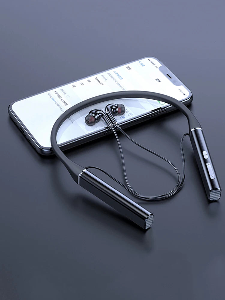 Black wireless magnetic neckband headphones resting next to a smartphone.