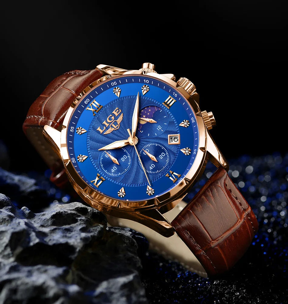 Men's classic chronograph watch with a blue patterned dial, gold-tone case, and brown croc-effect leather strap.