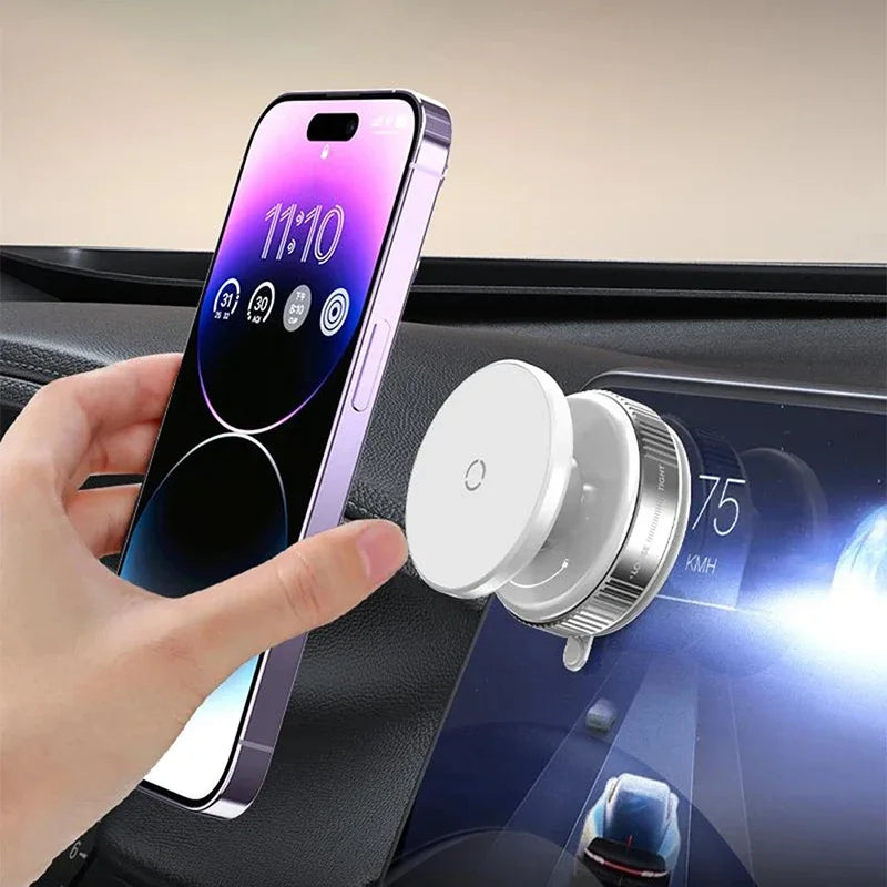 White magnetic car phone mount attached to a dashboard screen, being used with a purple smartphone.
