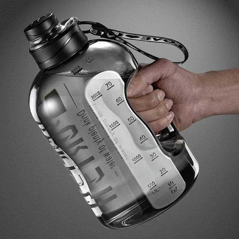Large, translucent black sports water bottle with a carry strap, integrated handle, and printed volume markers.