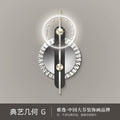 Modern geometric LED wall clock with a circular face, minimalist black accents, gold hands, and silver metallic trim.