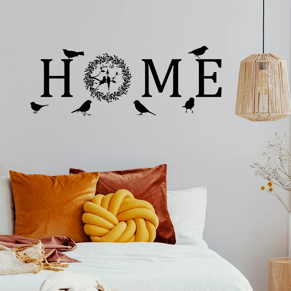 Black adhesive wall sticker featuring the word "HOME" with a floral wreath and silhouettes of birds.