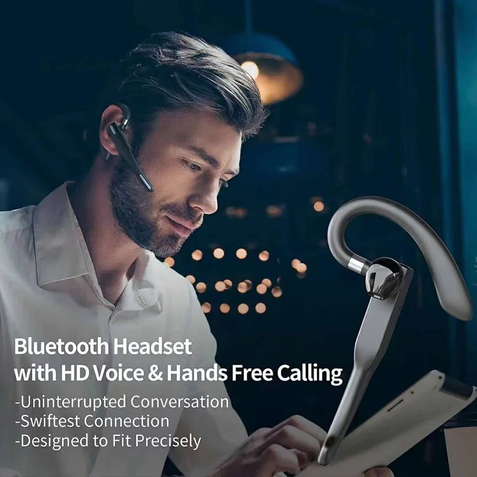 A man wearing a sleek, grey wireless Bluetooth headset with a secure ear hook design for hands-free calling.