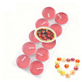 Pack of red strawberry-scented tea light candles with wicks, shown in clear packaging with a fruit-themed label.